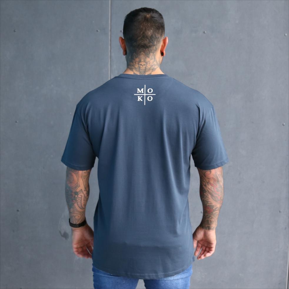 Mens blue tshirt with white maori wording design. Moko - maori artform or tattoo. Back view