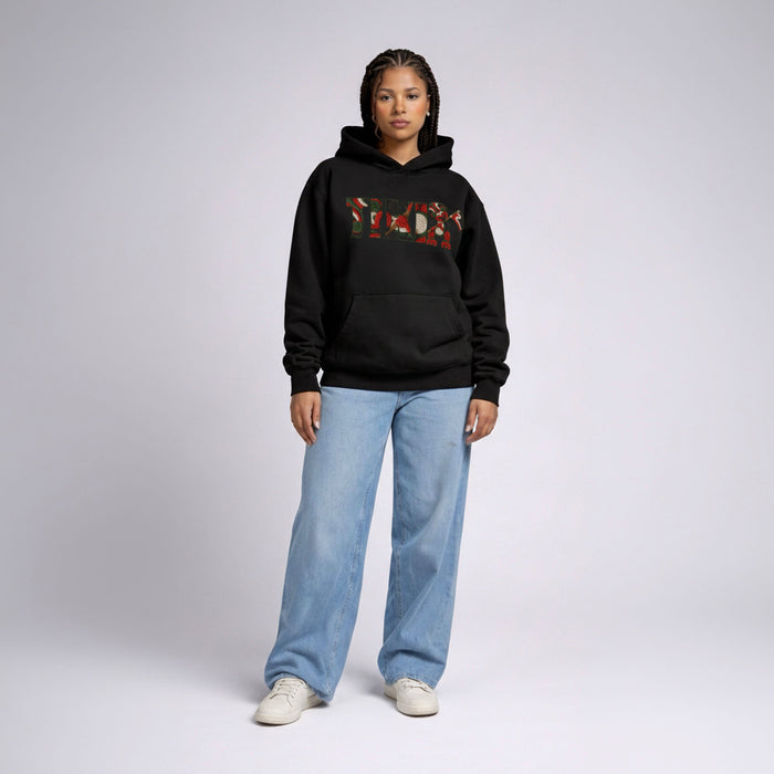 Front-facing female model in Cravass Tiki hoodie featuring Māori-inspired TIKI artwork and textured woven streetwear graphic