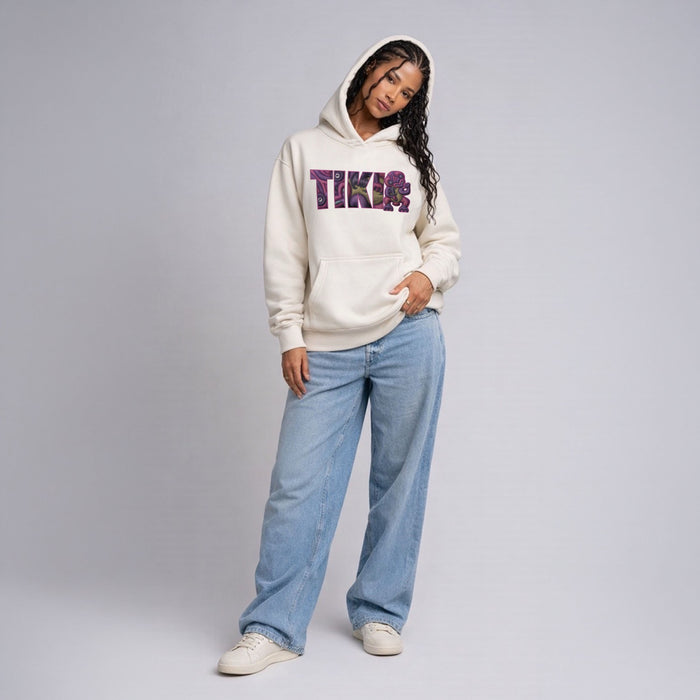 Female model wearing Cravass Waiporoporo Tiki hoodie in ecru colour, Māori streetwear pullover with purple graphic design, full body studio shot