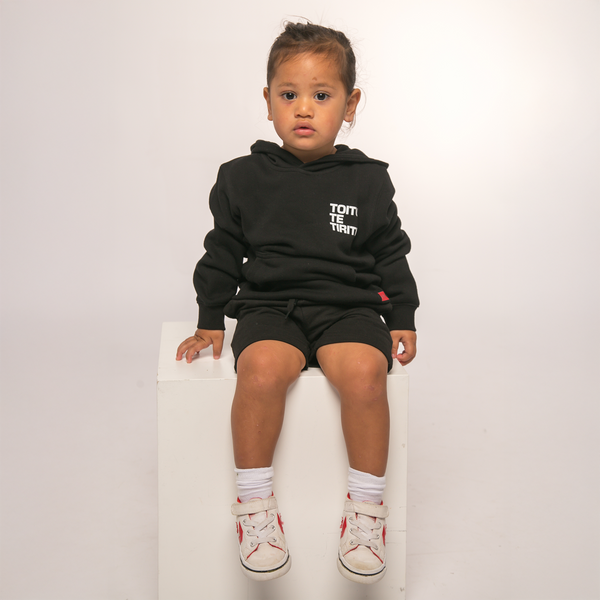 Front view of Te Kara Toi Tu Tiriti Kids Hoody in black, featuring 'Toitū te Tiriti' text