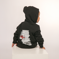 Back view of Te Kara Toi Tu Tiriti Kids Hoody in Black, showcasing the cultural design.
