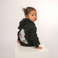 Back view of Te Kara Toi Tu Tiriti Kids Hoody in Black, showcasing the cultural design.
