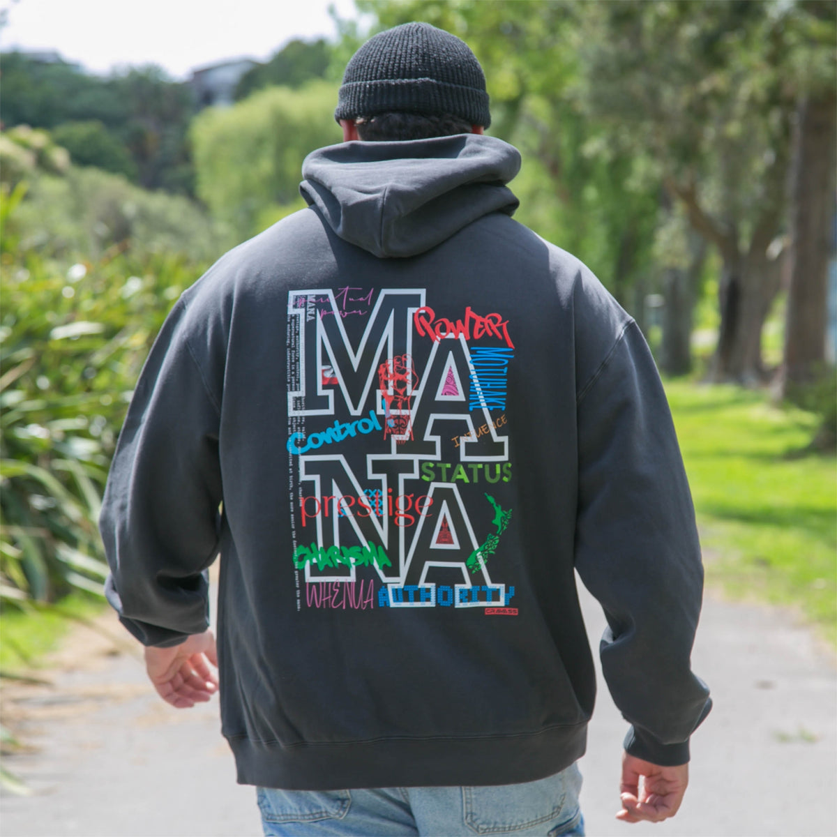 Men's faded black hoodie with Maori art and design from cravass clothing. 