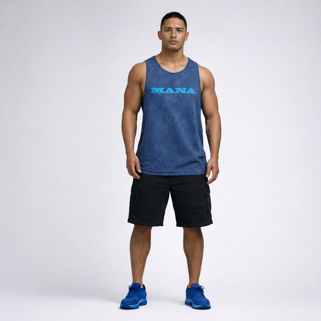 Man wearing a blue tank top with 'MANA' logo and black shorts on a white background Black acid wash singlet with Mana wording on front. Maori Streetwear