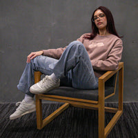 Woman wearing Cravass Pīwakawaka Hazy Pink Women's Crew with embroidered native bird artwork