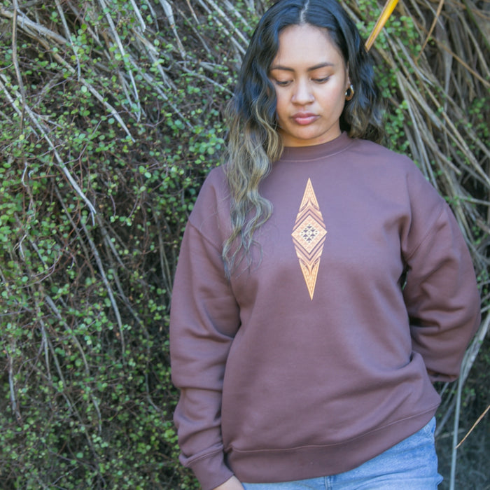 Women's jersey with brown contemporary Maori design.