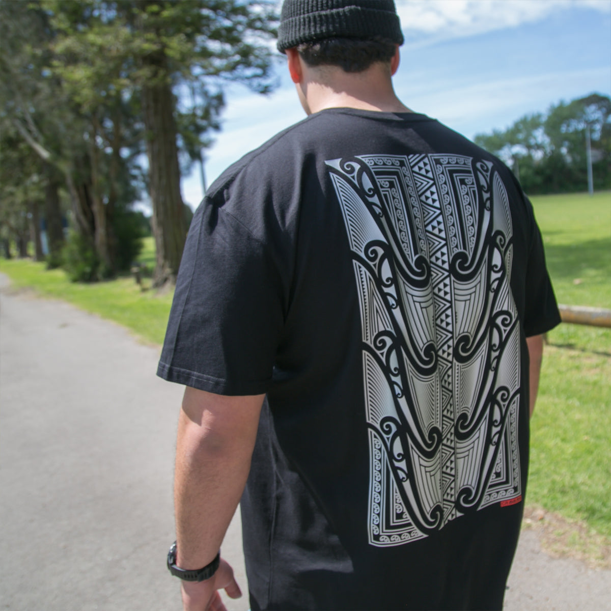 Men's black T-shirt featuring a silver Māori design from Cravass Clothing.