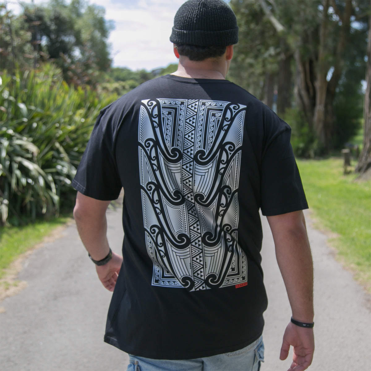 Men's black T-shirt featuring a silver Māori design from Cravass Clothing.