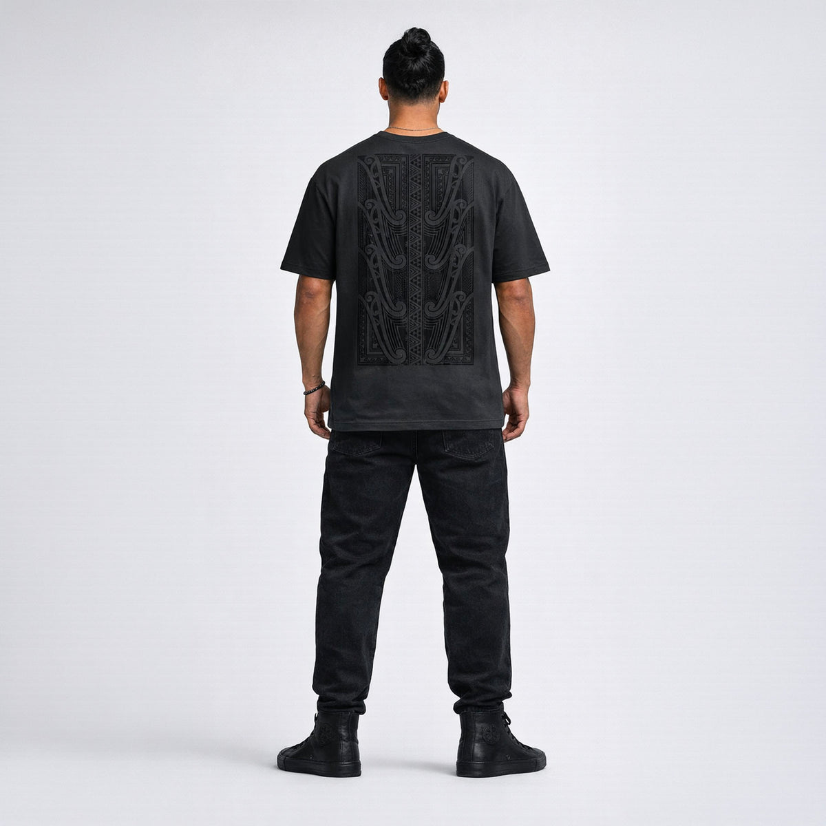 Mens black t-shirt with original Maori design on the back, standing against a white background