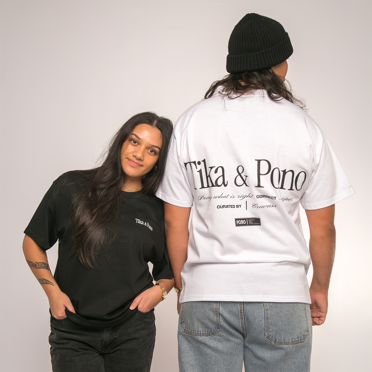 Two people wearing black and white t-shirts with 'Tika & Pono' branding.