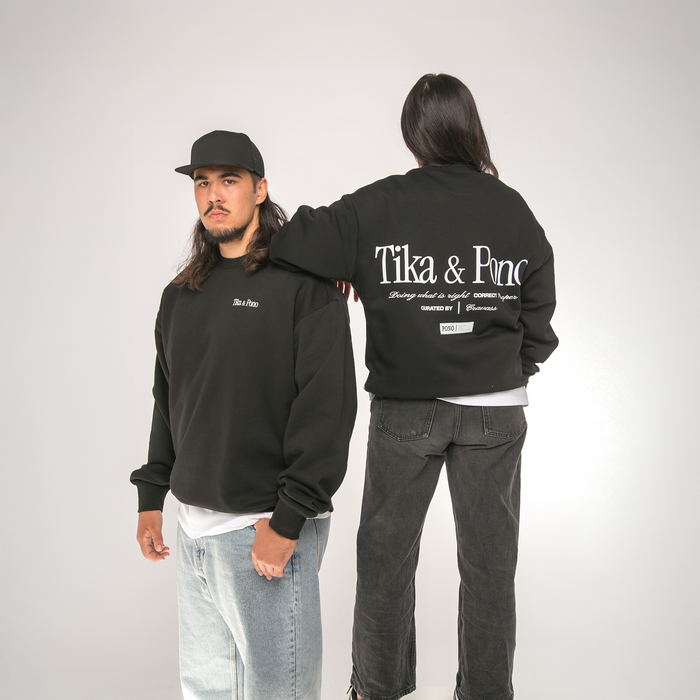 Two people wearing black sweatshirts with 'Tika & Pono' branding, one facing forward and the other showing the back.