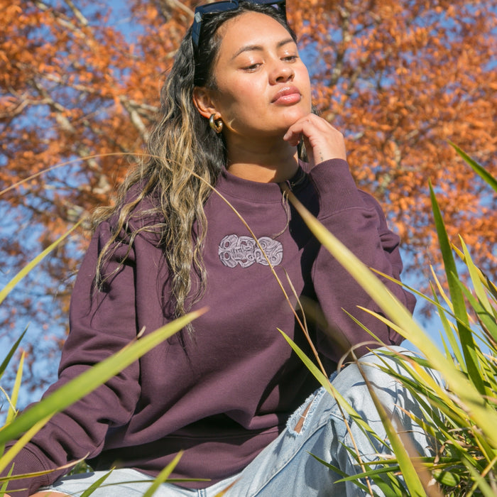 Women's purple heavy crew with embroidered purple tiki.