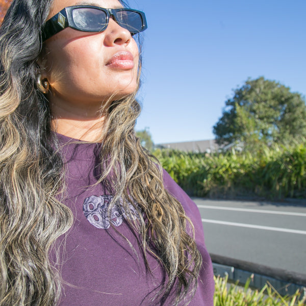 Women's purple heavy crew with embroidered purple tiki.