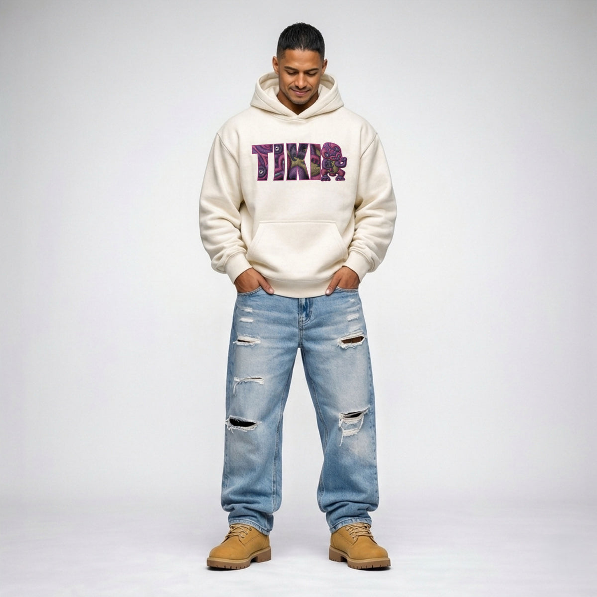 Cravass Waiporoporo Tiki hoodie in ecru colour, Māori streetwear pullover with purple graphic design, full body studio shot