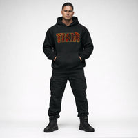 Black Cravass AHI Tiki hoodie worn by male model featuring bold red Māori-inspired TIKI graphic, New Zealand streetwear design