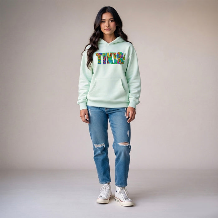 Model wearing Cravass Aniwaniwa Tiki Hoodie – Māori streetwear hoodie designed in New Zealand featuring colourful tiki lettering