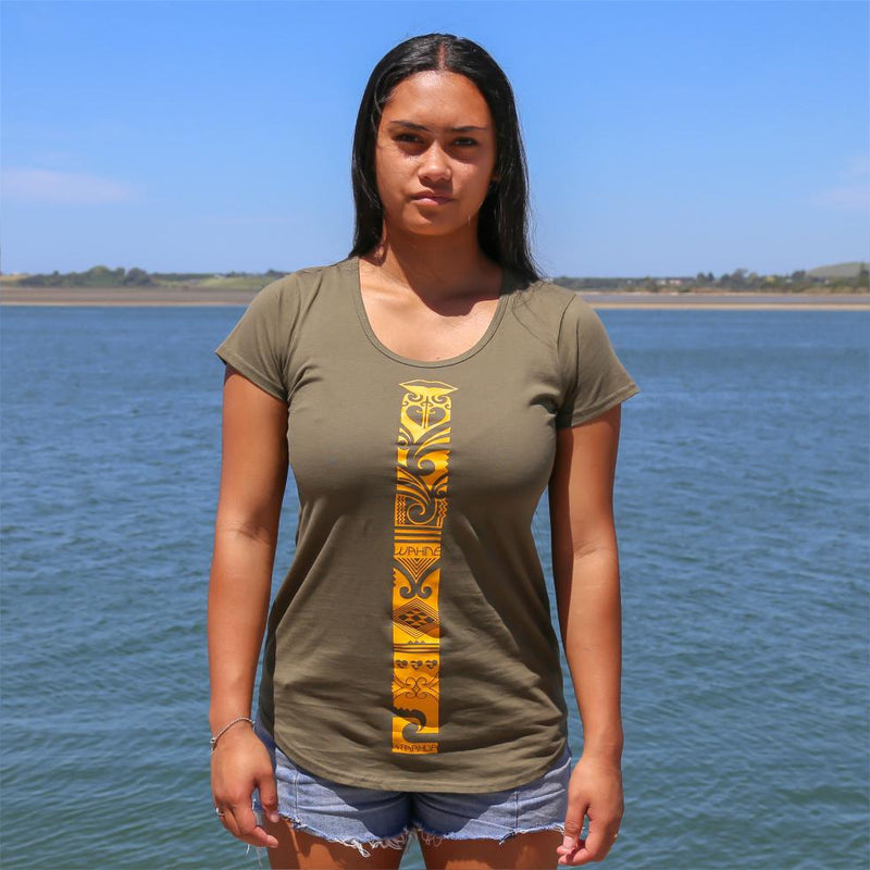 Women's green tshirt with yellow maori design stripe from cravass. Maori ta moko clothing. 