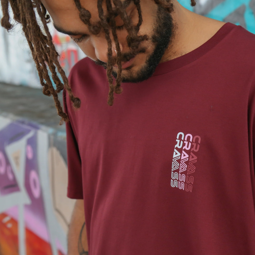 Front view of Men's burgundy t-shirt with pink, white and burgundy Maori art and design on the back.