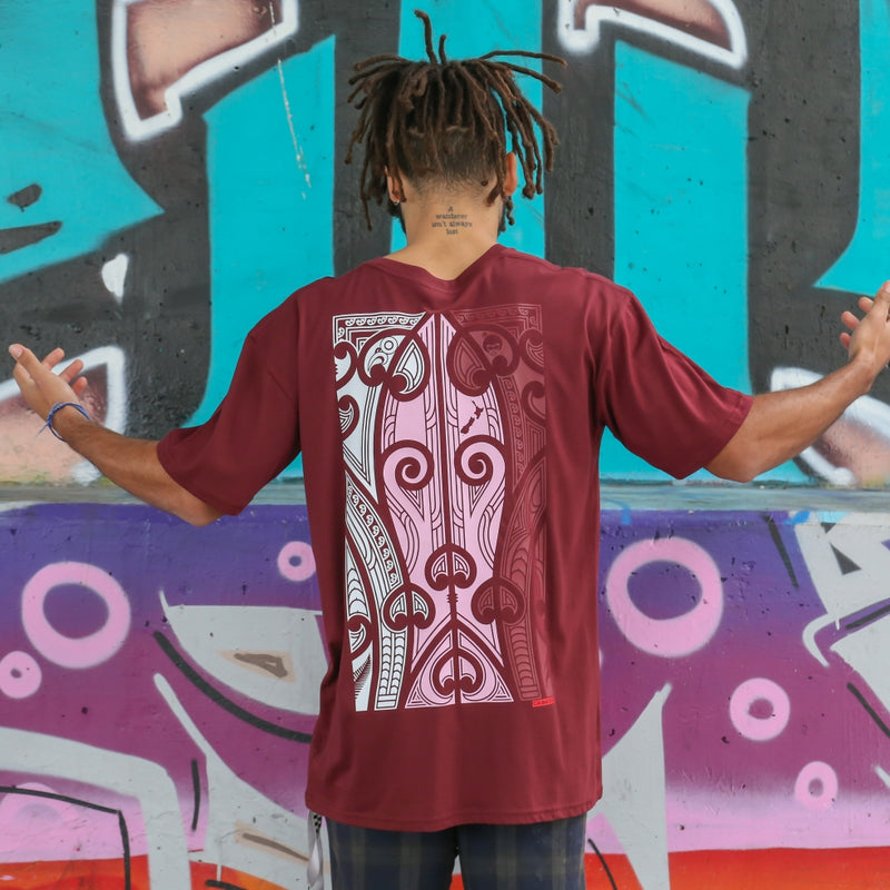 Men's burgundy t-shirt with pink, white and burgundy Maori art and design on the back.