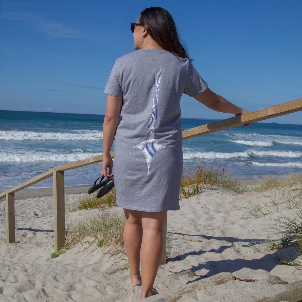 Model at the papamoa beach in tauranga wearing grey cravass dress.