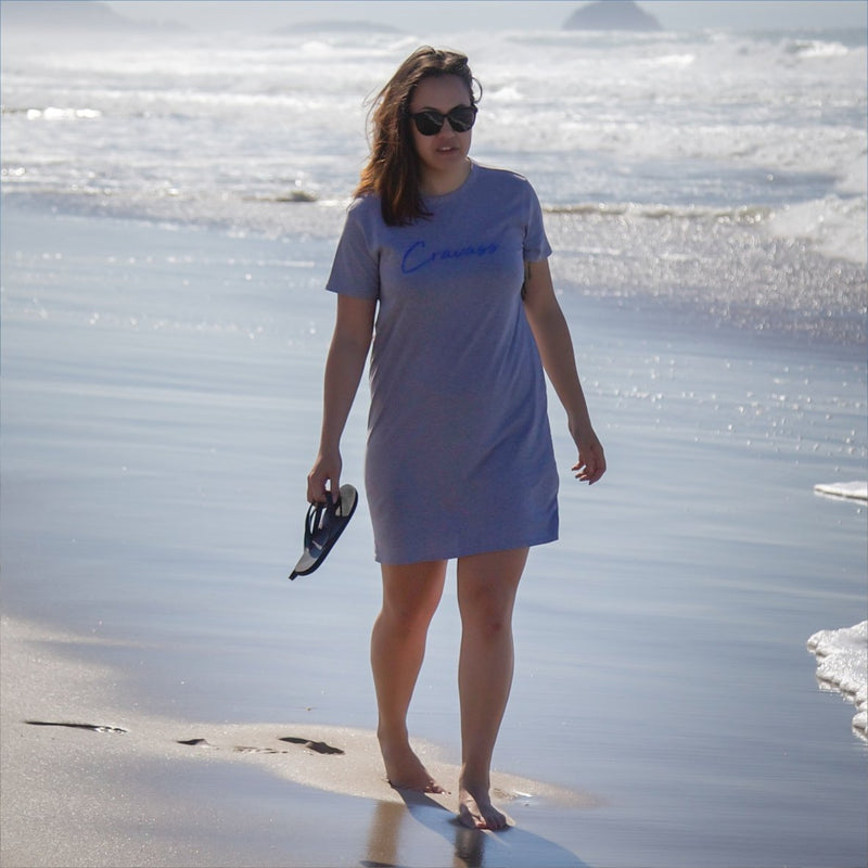 Beautiful wahine walking along the papamoa beach wearing a grey cravass tshirt dress.