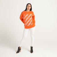 Women's orange crew jersey with white Maori poutama design from Cravass clothing