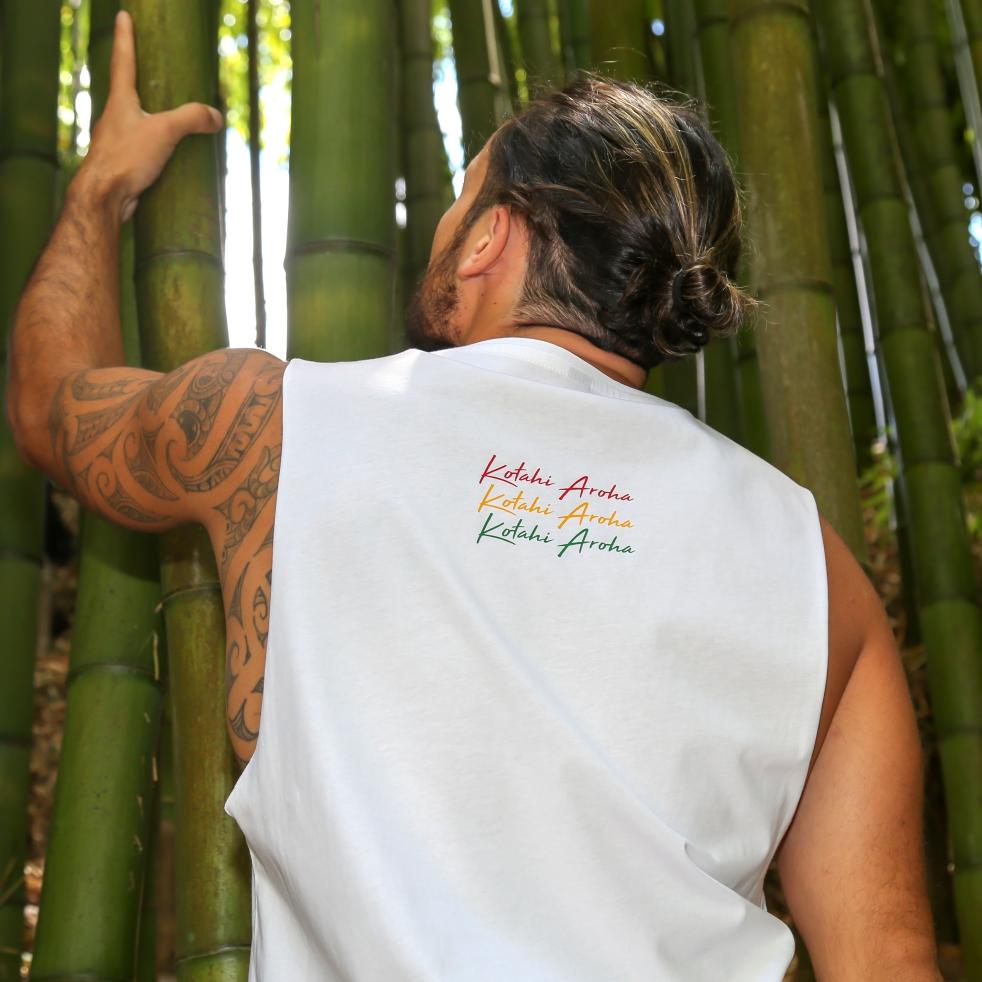 Model wearing White singlet with Rasta coloured Maori design from New Zealand clothing brand Cravass