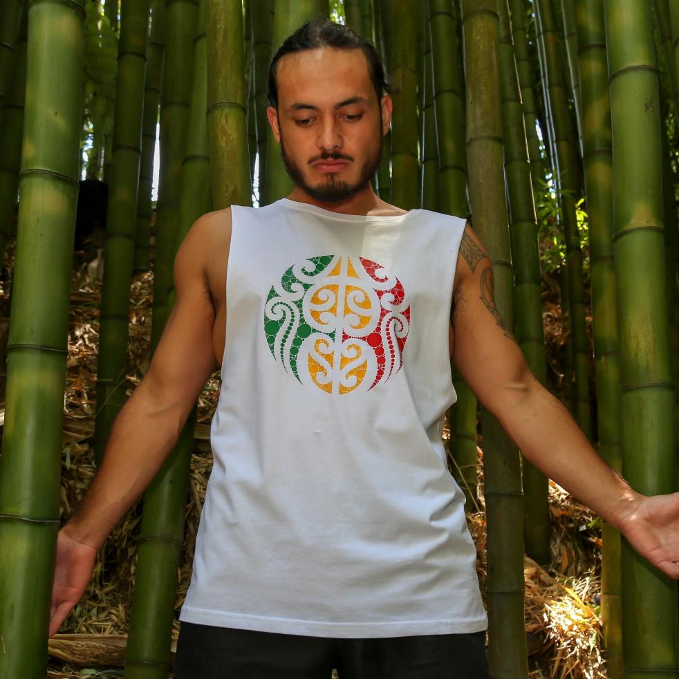 Model wearing white singlet with Rasta coloured Maori design from New Zealand clothing brand Cravass, bamboo forest 