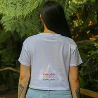 Women's white crop top with Rasta coloured Maori design from Cravass Clothing. Back