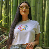 Women's white crop top with Rasta coloured Maori design from Cravass Clothing.