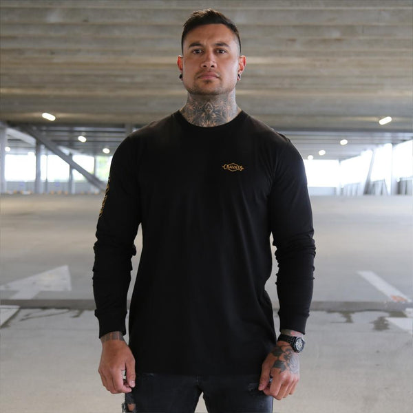 Mens black long sleeve tshirt with yellow Maori design. Meaning of Mana. Front view.