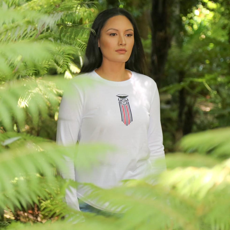 Women's white long sleeve t shirt with black and red Maori Moko Kauae design from Cravass Clothing. Maori Clothing.