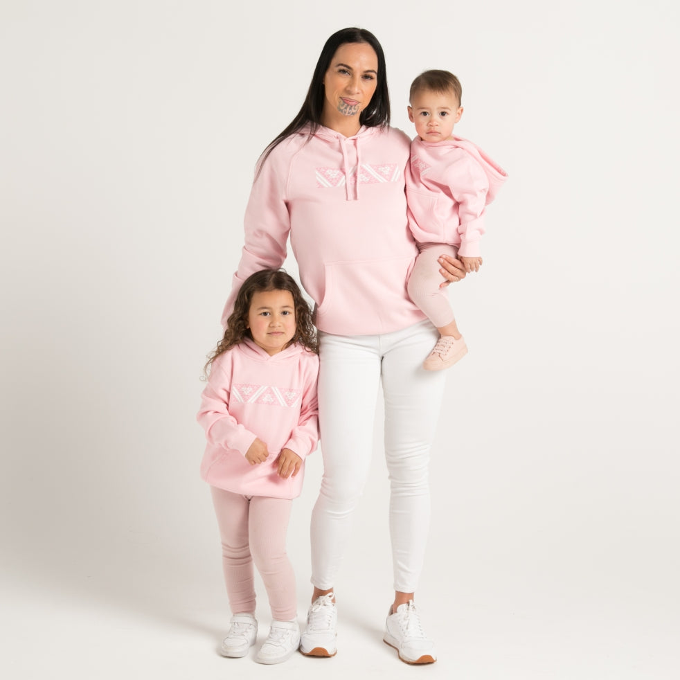 Pink kids hoodie with pink and white Maoro Taniko design from Cravass Clothing New Zealand.