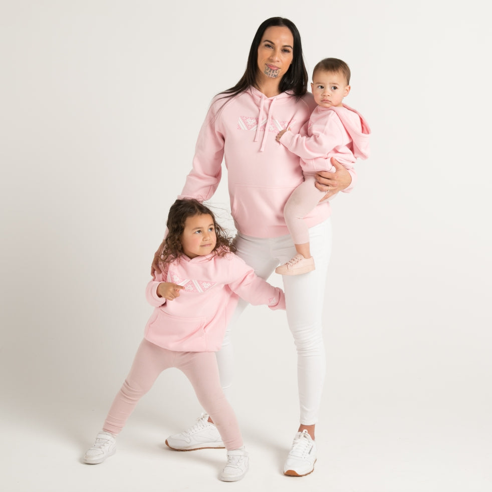 Pink kids hoodie with pink and white Maoro Taniko design from Cravass Clothing New Zealand.