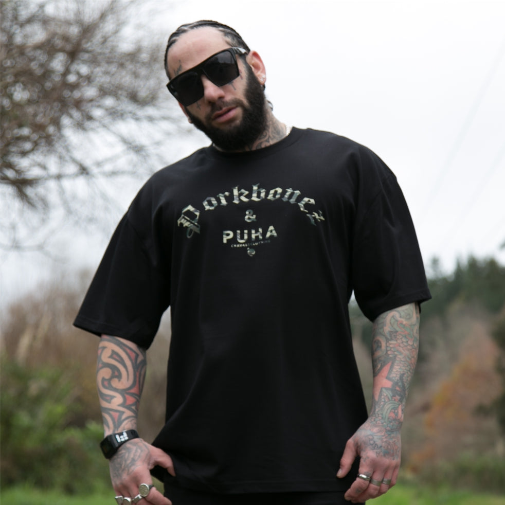 Men's black heavyweight T-shirt with Camo Pork bones and Puha design.