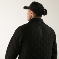 Black quilted men's jacket with embroidered Taiaha design. Original Maori design from Cravass clothing. 