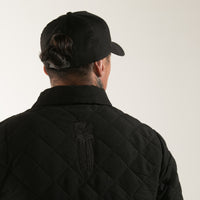 Black quilted men's jacket with embroidered Taiaha design. Original Maori design from Cravass clothing. 