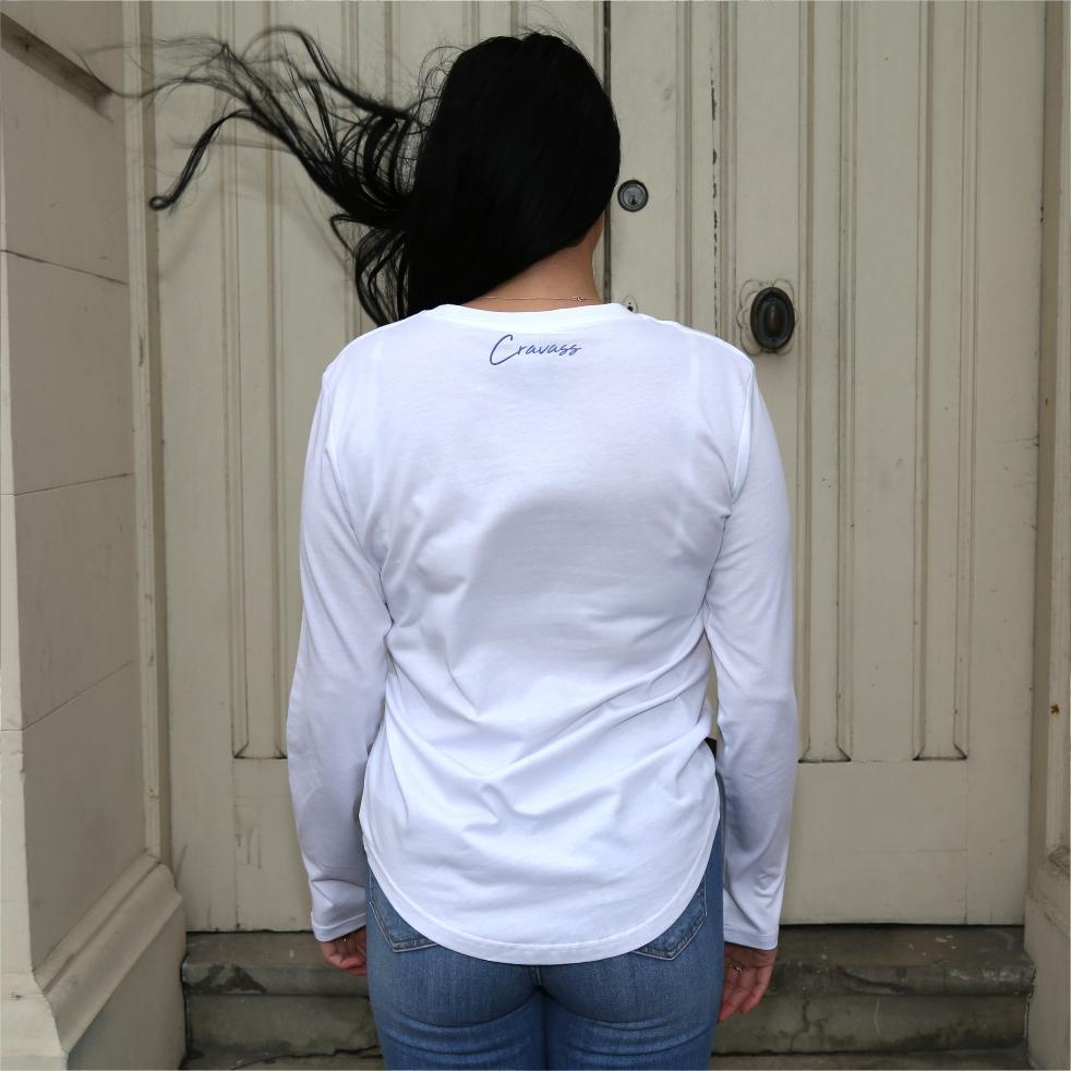 Women's white long sleeve tshirt with blue maori designs and Cravass logo. Back view
