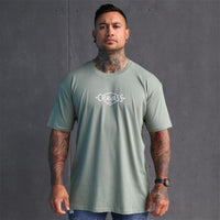 Mens sage coloured tshirt with white triangle maori design on the back. Maori clothing. Front view
