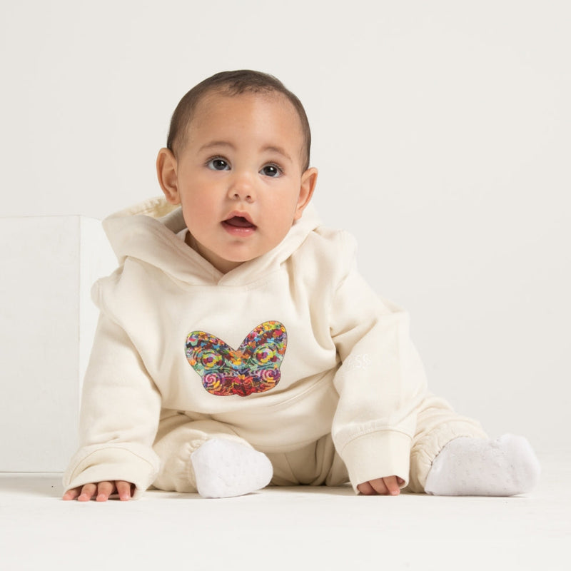 Cute baby wearing white hoodie track suit with Tiki Design from Cravass Clothing.