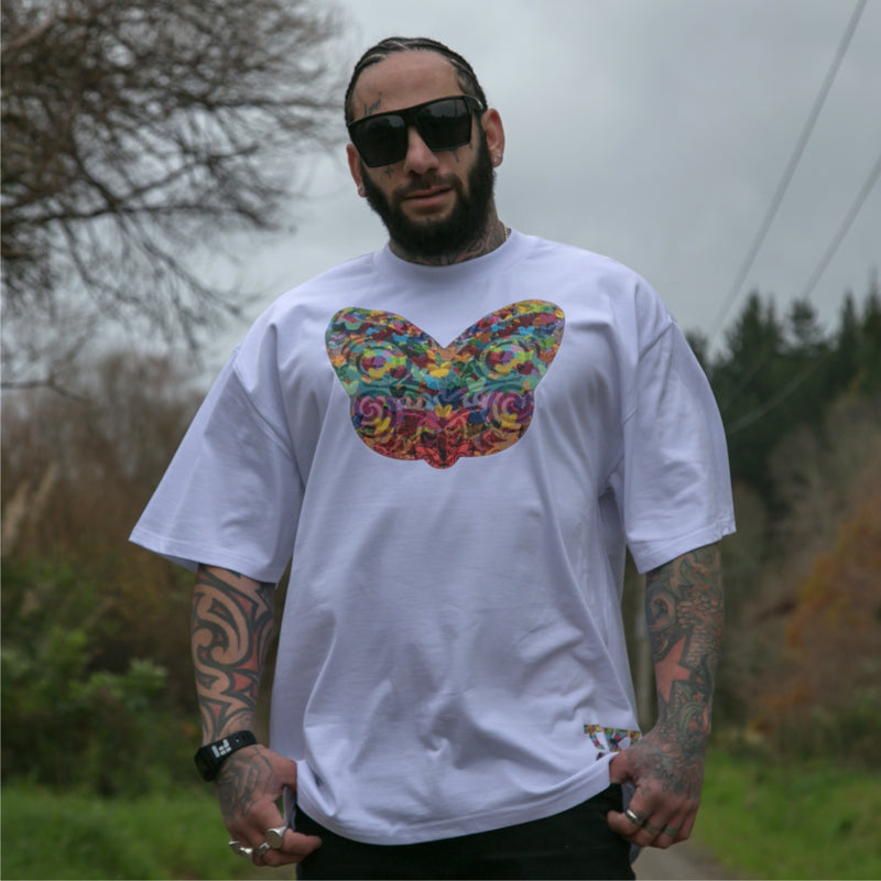 Men's white heavyweight t-shirt with colourful Maori tiki design from Cravass clothing.